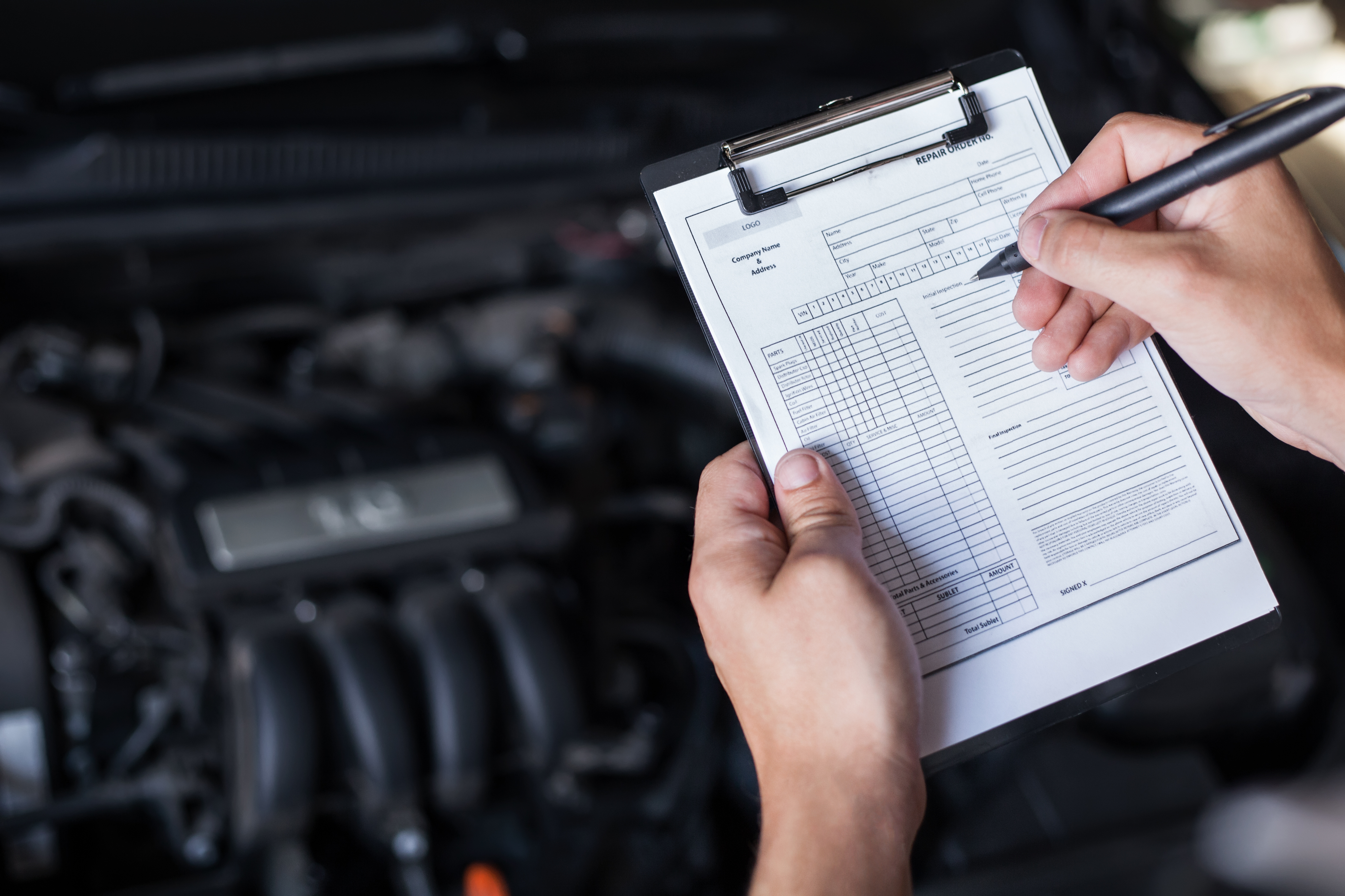 Vehicle inspection checklist with car engine in background