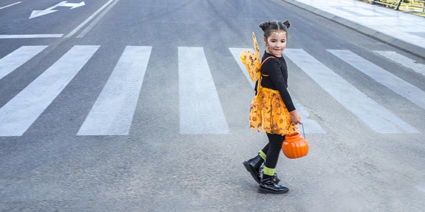 Child crosses the street on Halloween