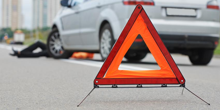 Pop up roadside warning cones with an out of focus car on the side of the road 