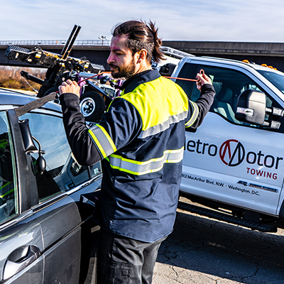 Roadside assistance technician performs a lock-out service on a locked vehicle