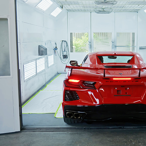 Luxury vehicle pulls into the Metro Motor collision repair paint booth