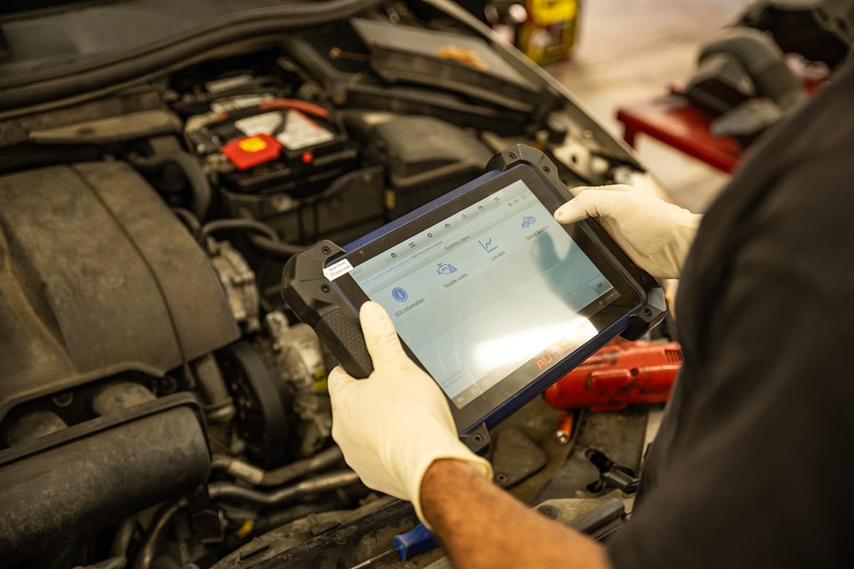 An ASE-certified technician inspects a vehicle
