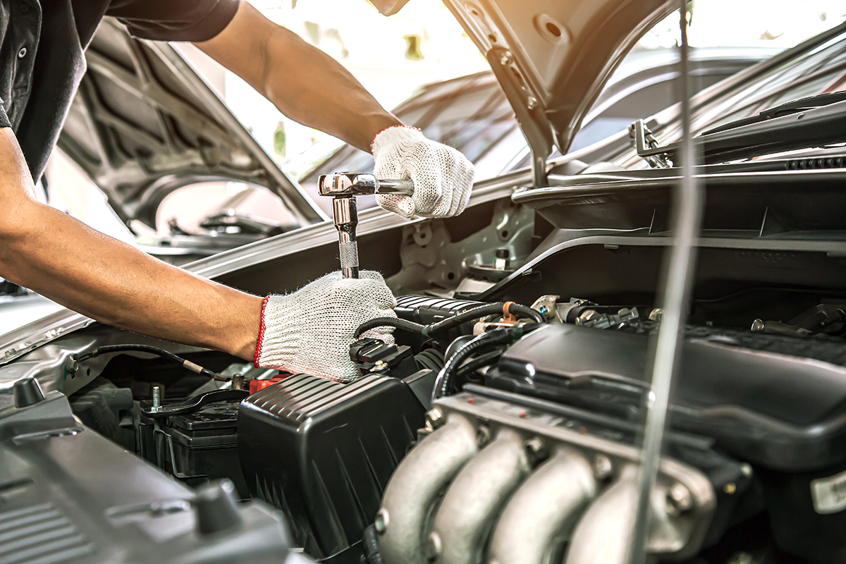 Auto mechanic in DC works on an engine