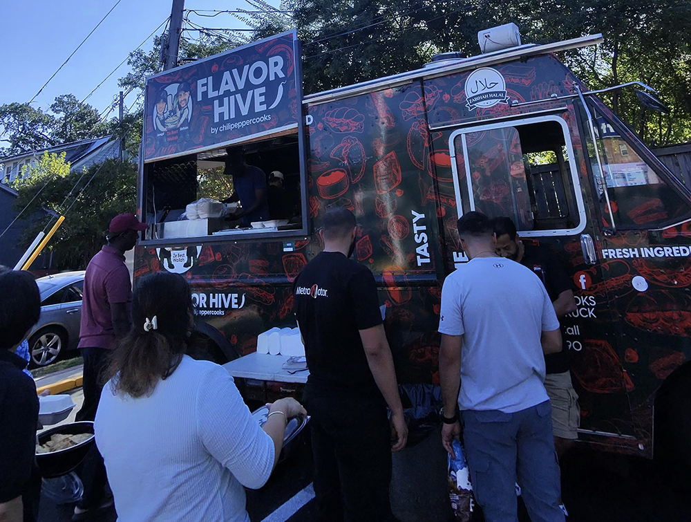 Neighbors gather at the Flavor Hive food truck parked at Metro Motor in Clarendon