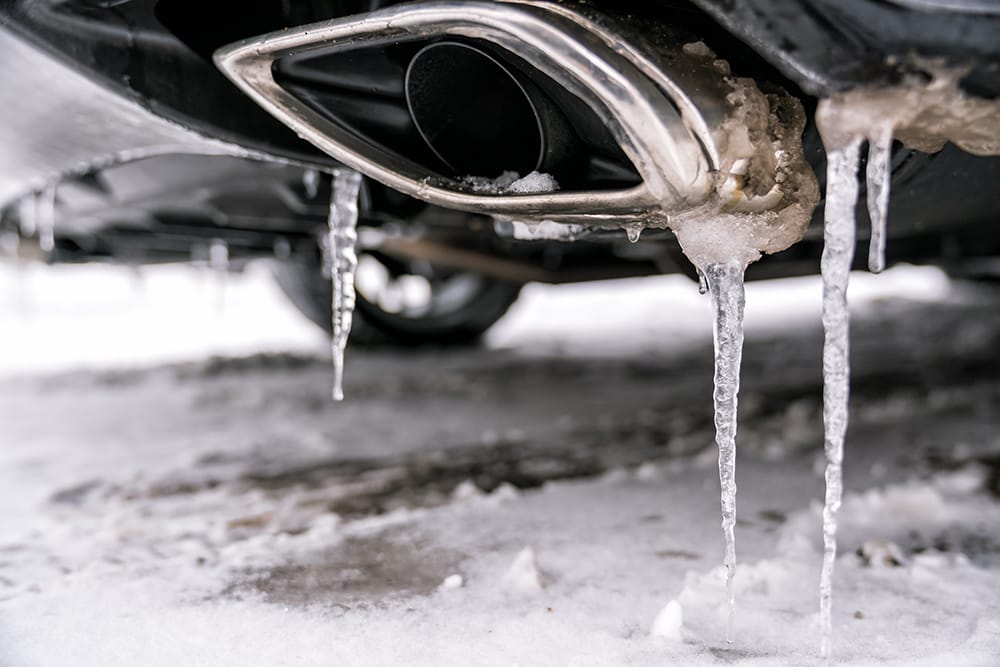 How long should I let my car warm up in winter? Ice drips from a muffler.