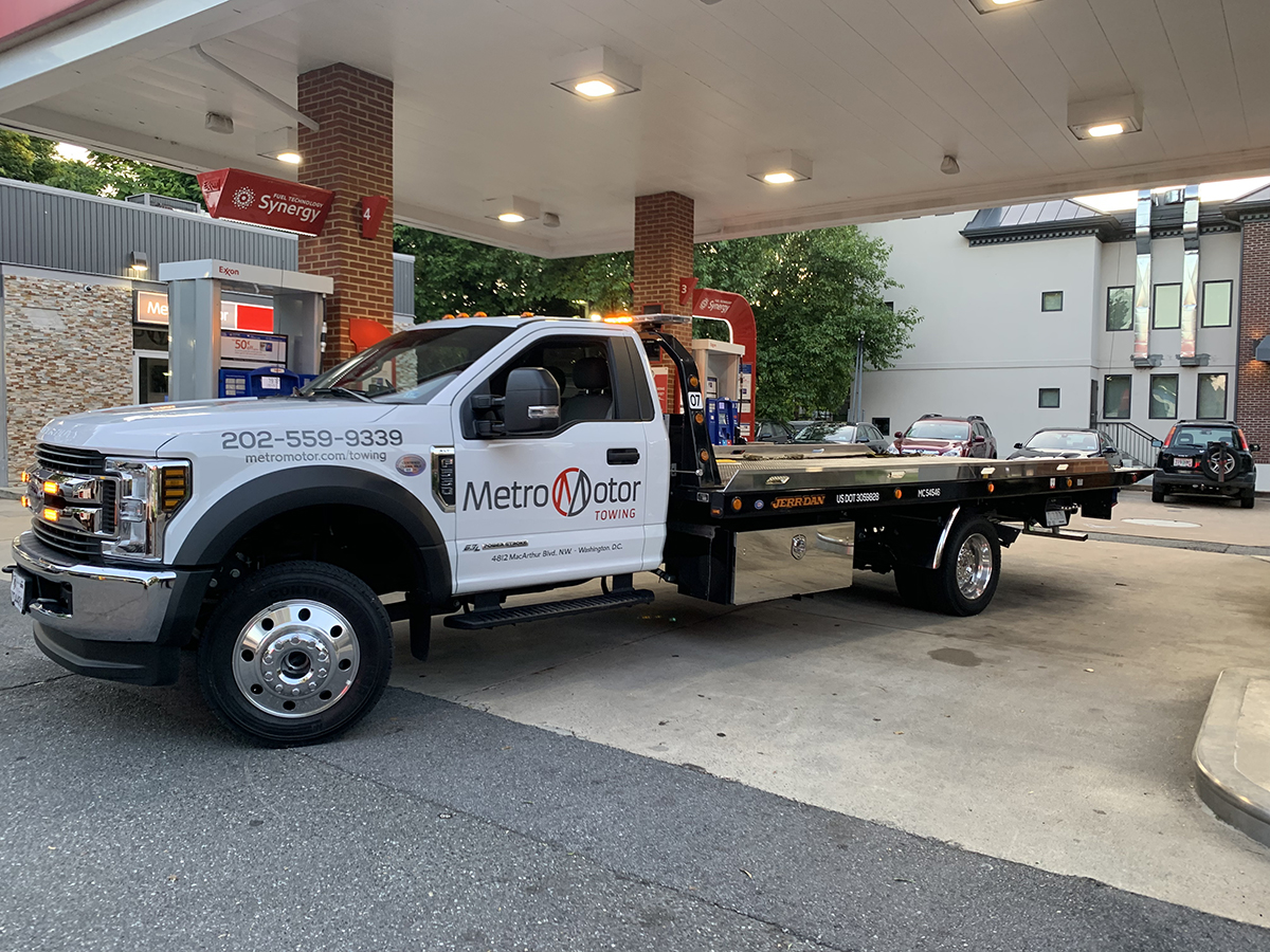 A Metro Motor tow truck refuels at a gas station in Washington, D.C.