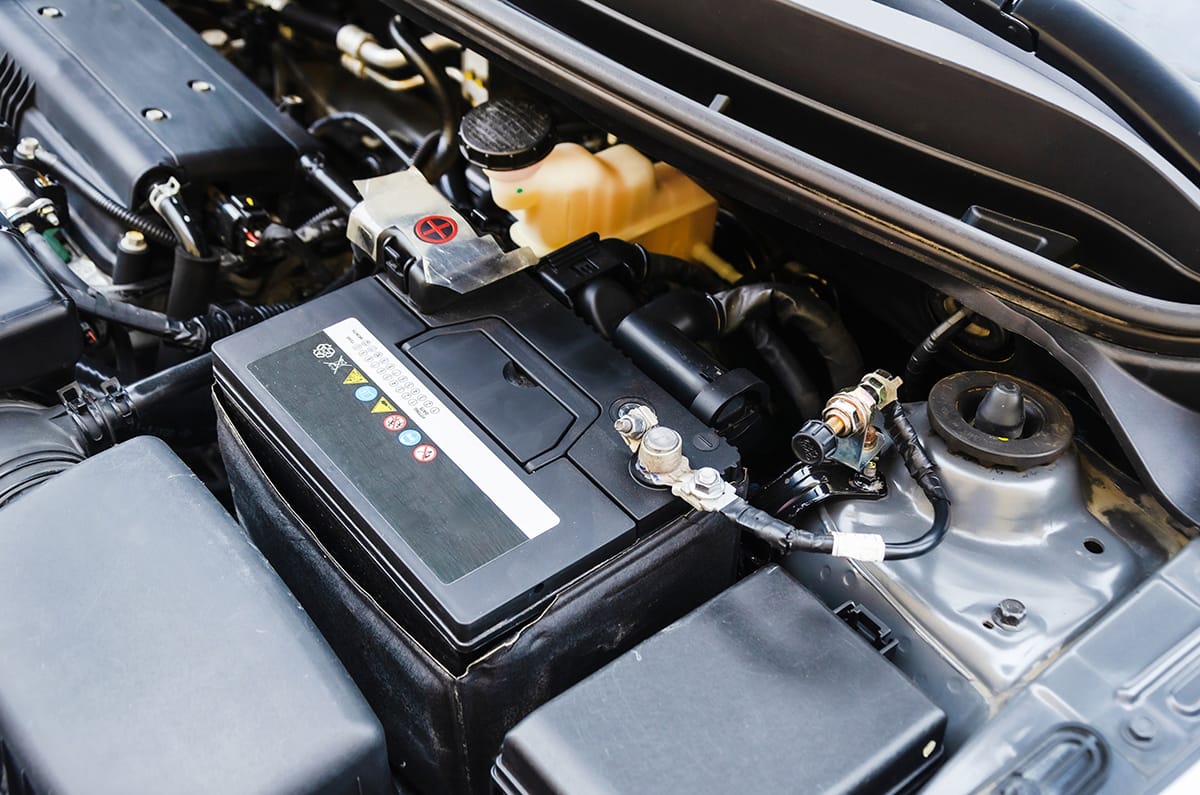 Installed car battery is shown under a vehicle's open hood