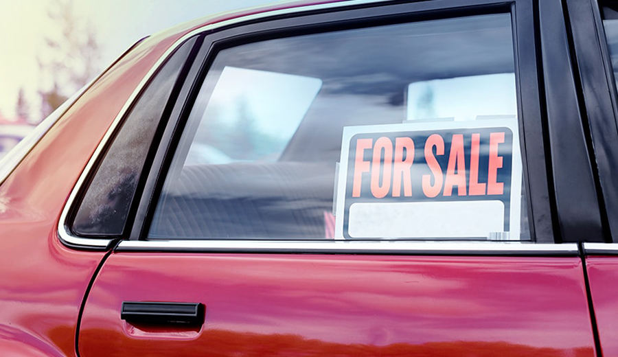 For Sale Sign in a Used Car Window