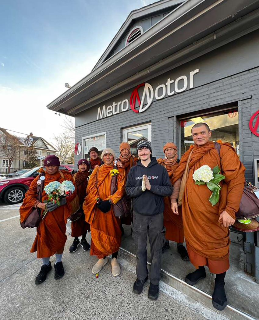 Metro Motor team member poses with Walk for Peace monks