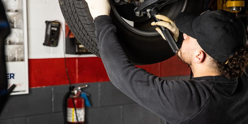 Metro Motor auto repair technician inspects a vehicle's brake system