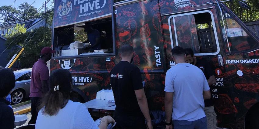 Neighbors gather at the Flavor Hive food truck parked at Metro Motor in Clarendon