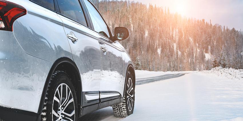 SUV drives across a winter scene