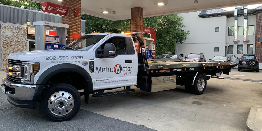 A Metro Motor tow truck refuels at a gas station in Washington, D.C.