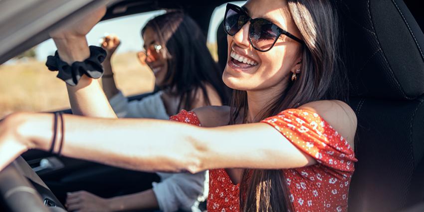 Two women take a road trip in a car