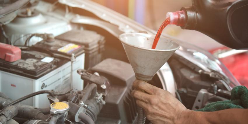 Pouring fluid into a car engine spout